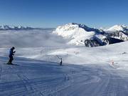 Skier au-dessus des nuages dans le domaine skiable Alpe Lusia
